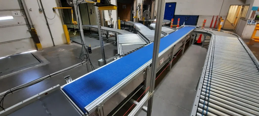 A conveyor belt that is sorting product into three different semi trailers.