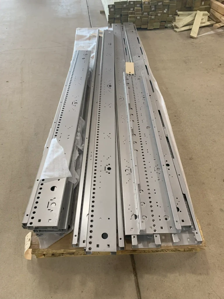 A long pallet with conveyor rails sitting on top.