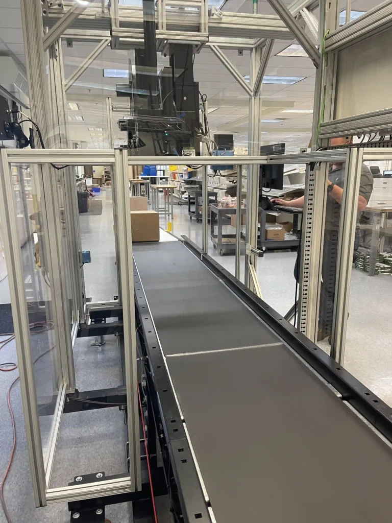 A conveyor with a SLAM Line which is used to Scan, Label, Apply, and Manifest packages for shipping in a fulfillment center.