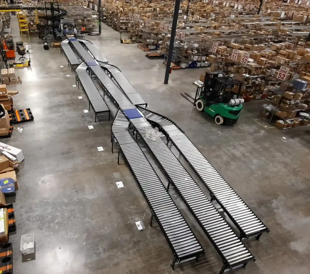 A conveyor system with three ModSort sorters used in a warehouse setting.
