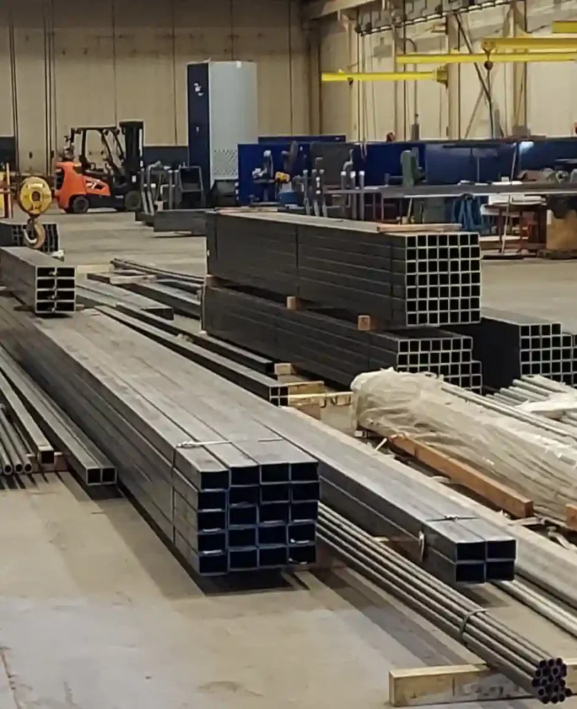 Unfinished steel components sitting on four by fours in the Fabrication Department.